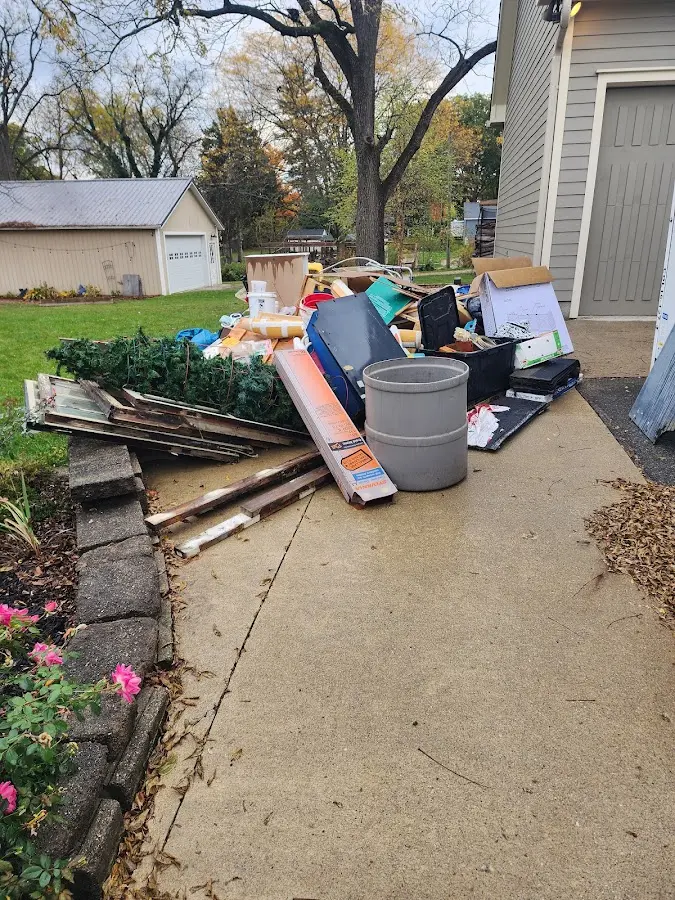 Dumpster being loaded with debris for Roofing Dumpster Rental in Notre Dame